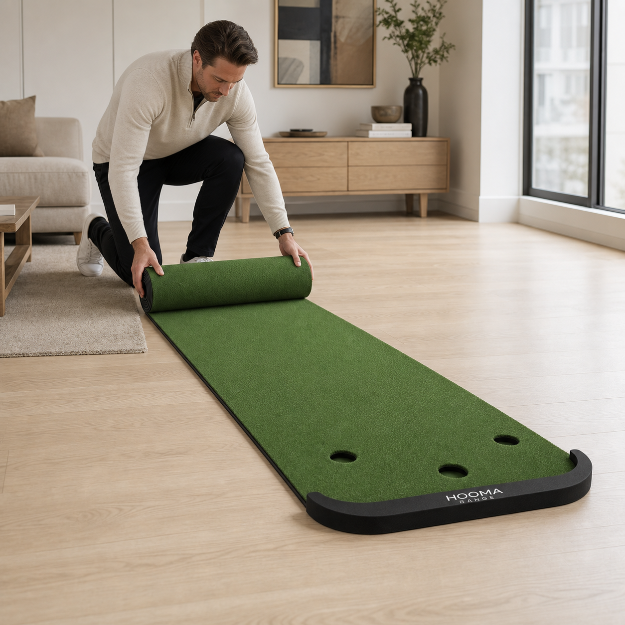 Golfer unrolling a HOOMA RANGE putting mat at home
